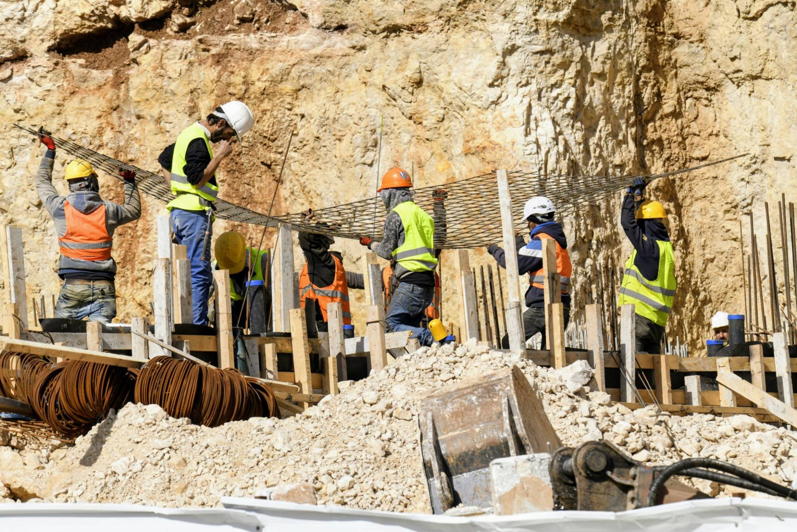 Construction crew placing rebar on a worksite