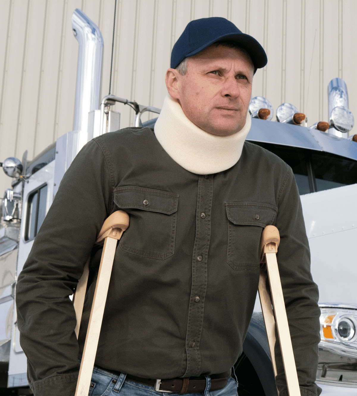 Injured man with neck brace and crutches by truck, in need of Personal Injury lawyer.