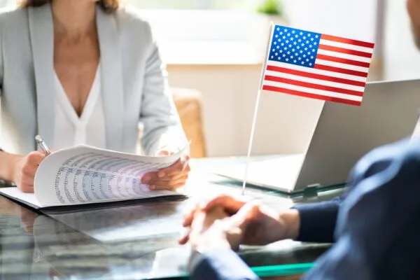 A man and woman in a meeting with an Immigration Attorney discussing immigration.